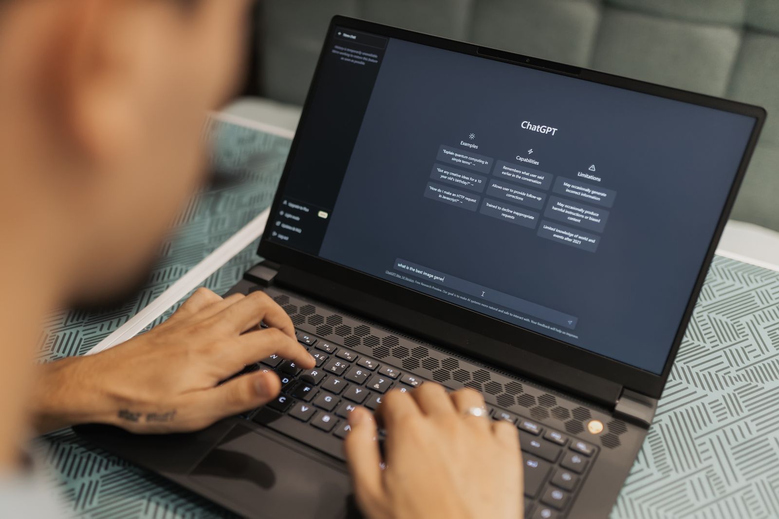 Person using a laptop with an AI chat interface open