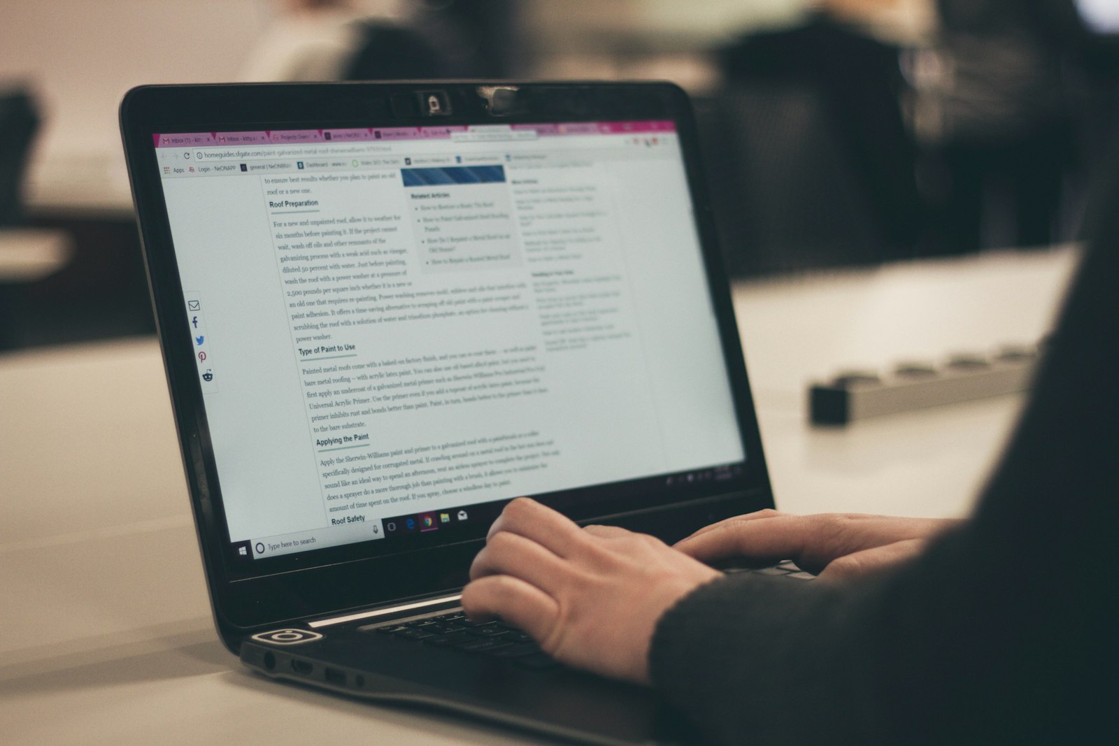 A small business owner typing on a laptop computer