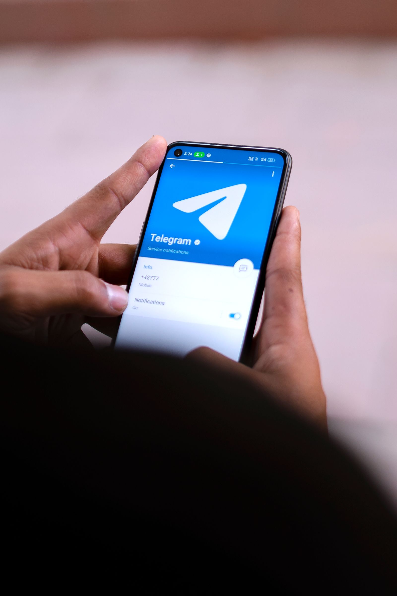 Hands holding a smartphone with a chat messaging app open