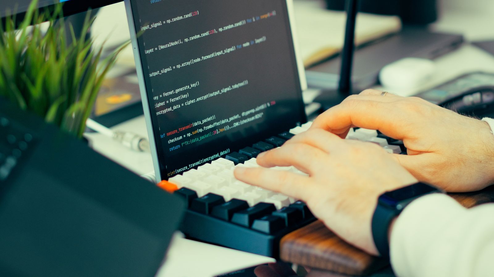 Close-up of a developer typing code on a keyboard