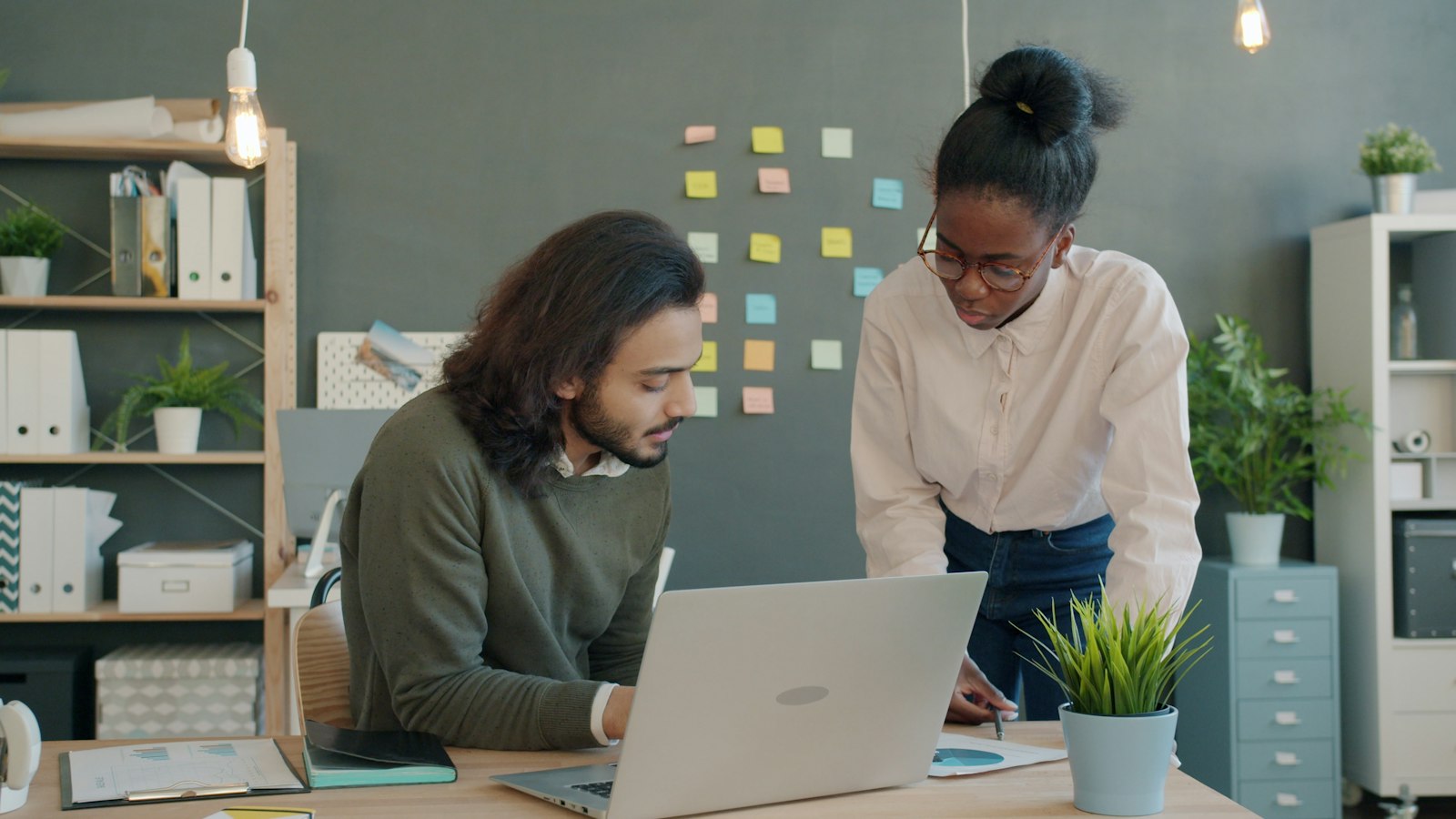 Two colleagues reviewing a project together at a desk