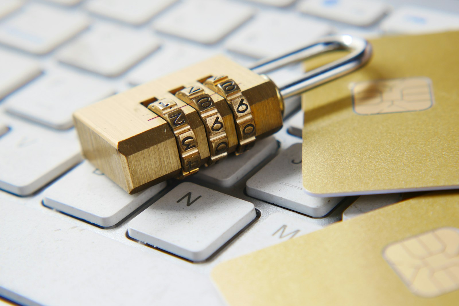 Golden padlock sitting on top of a computer keyboard