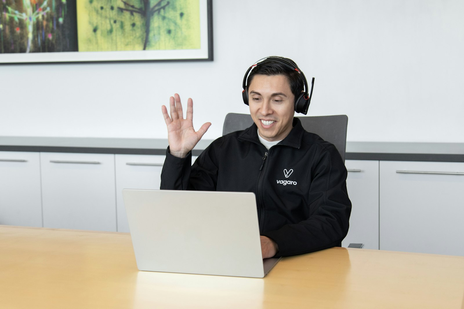 Support technician wearing a headset while working at a computer in an office