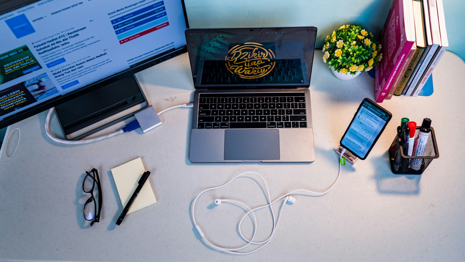 A laptop and phone side by side on a developer's desk