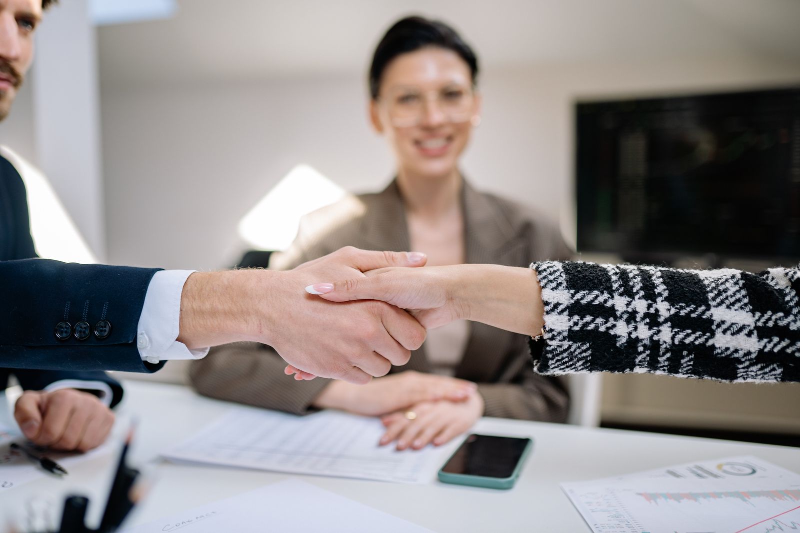Two business people shaking hands to seal a deal after a meeting