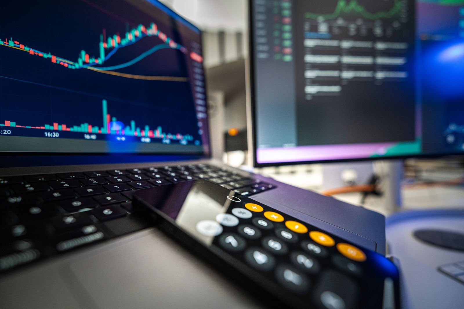 Financial charts and market data displayed on a screen