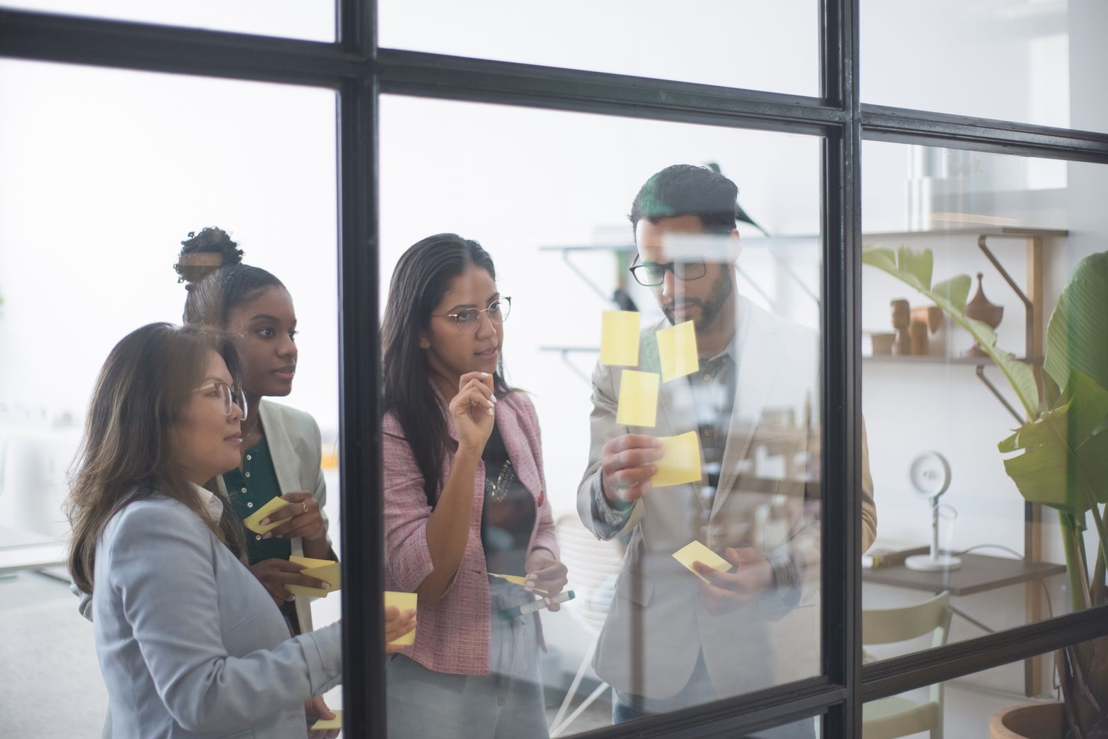 A group of business people collaborating on a plan with sticky notes