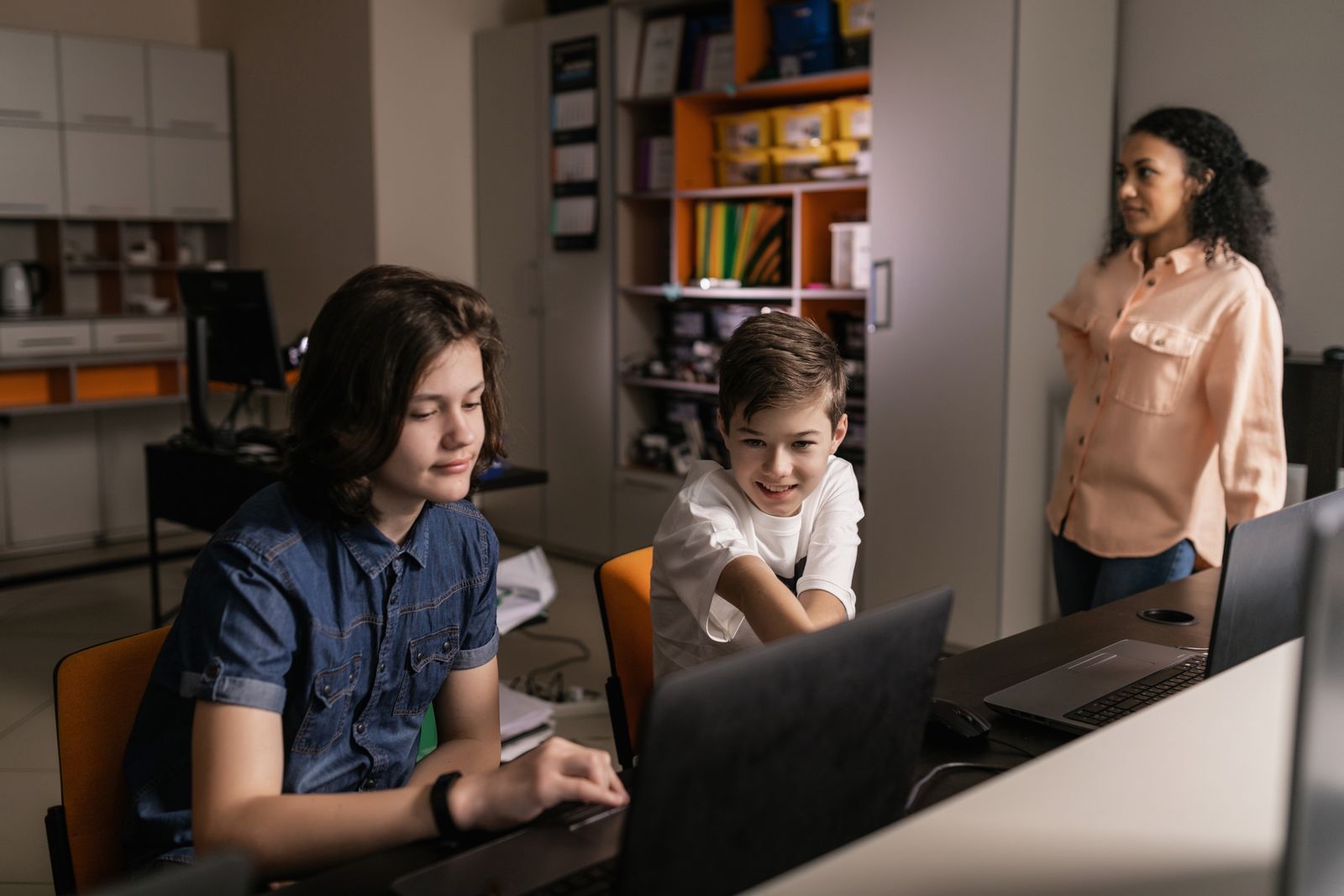 Students using laptops together in a classroom