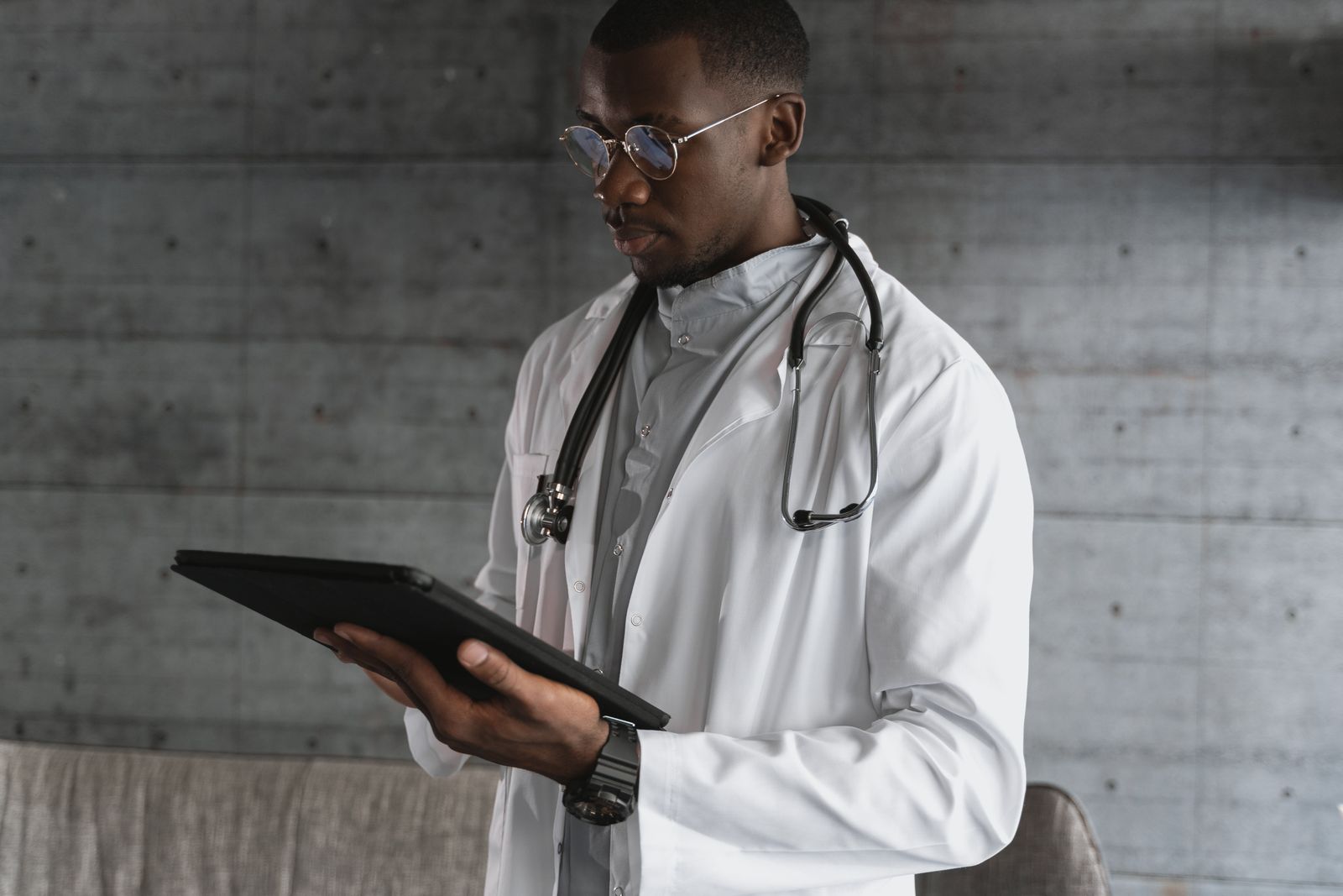 Doctor reviewing patient information on a digital tablet
