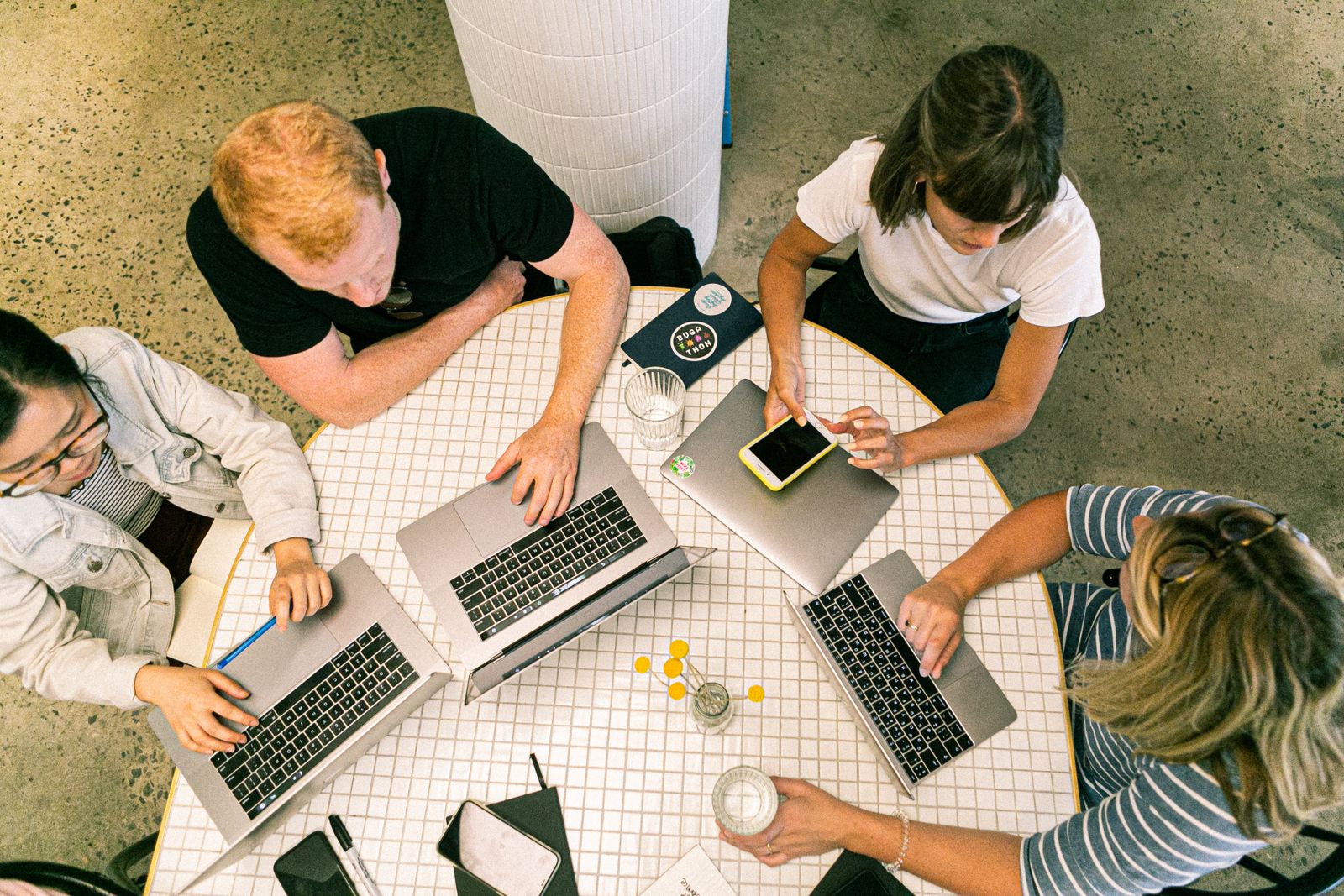 A remote team communicating using laptops and smartphones