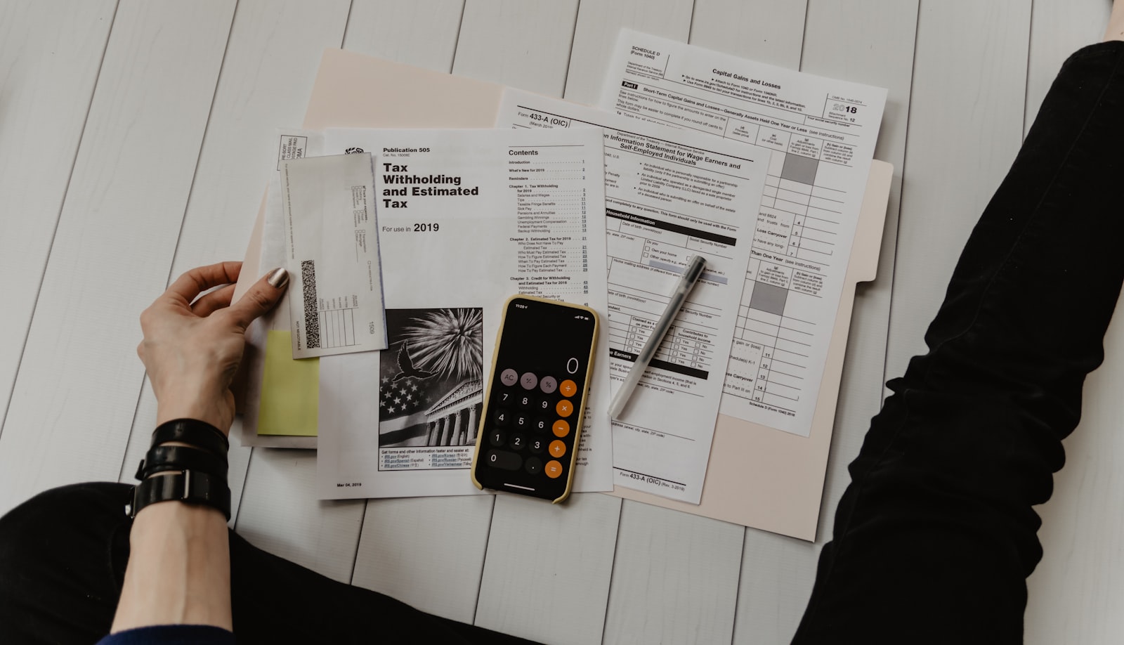 Comparing costs with a calculator and paperwork