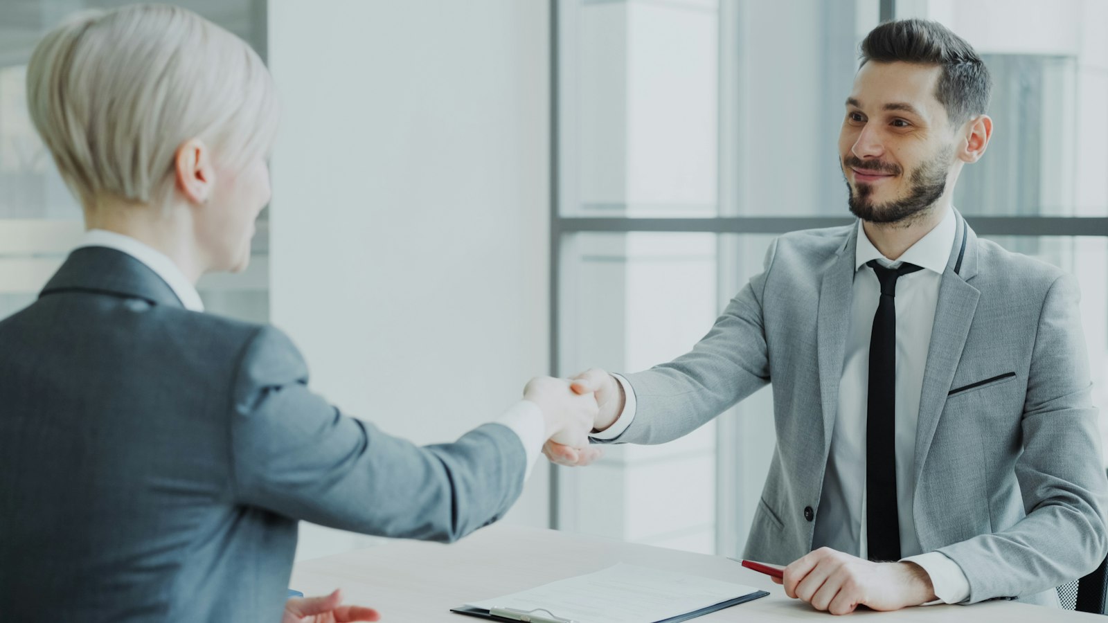 Two professionals shaking hands, representing the leadership credibility built into the site