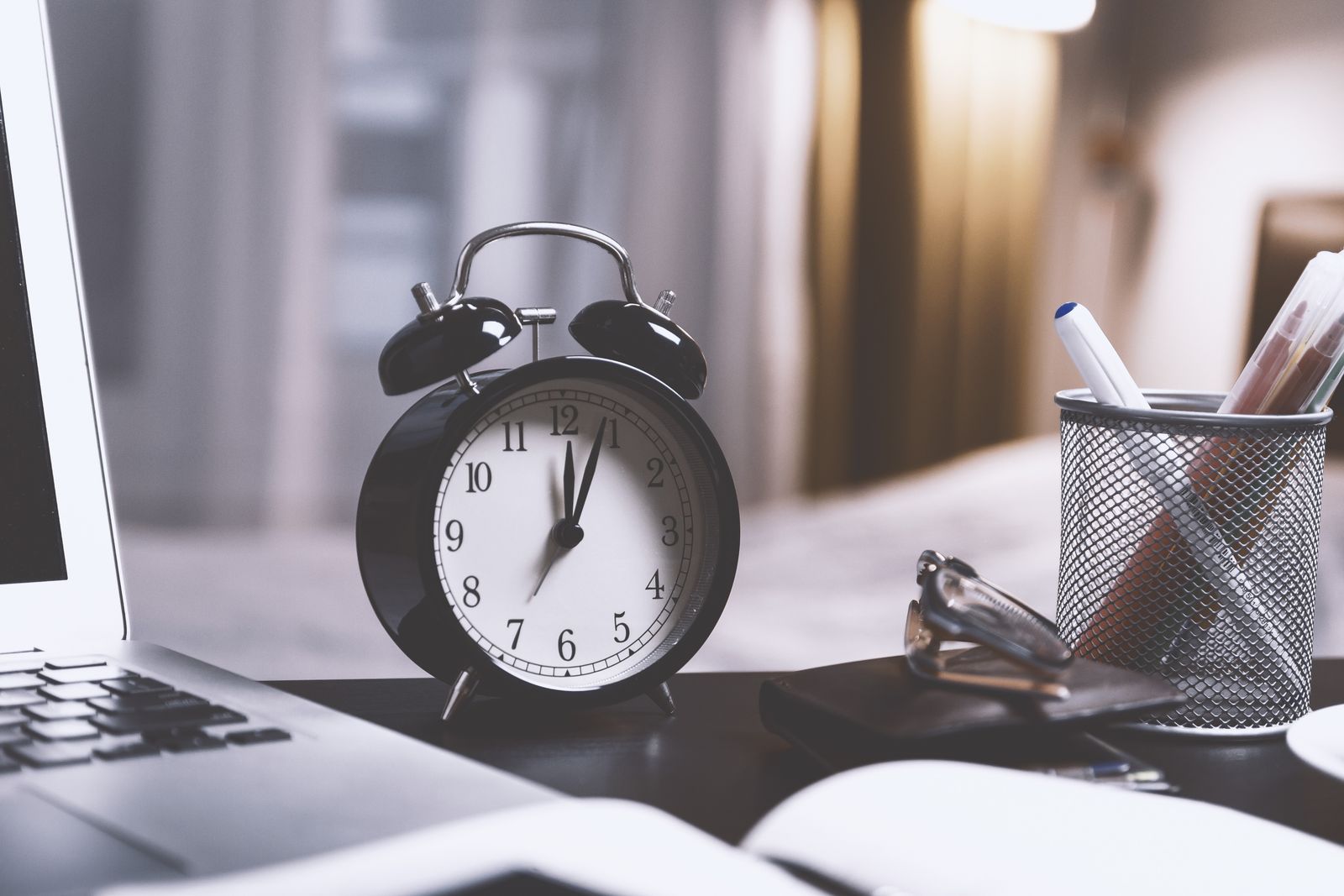 A twin-bell alarm desk clock sitting on a table