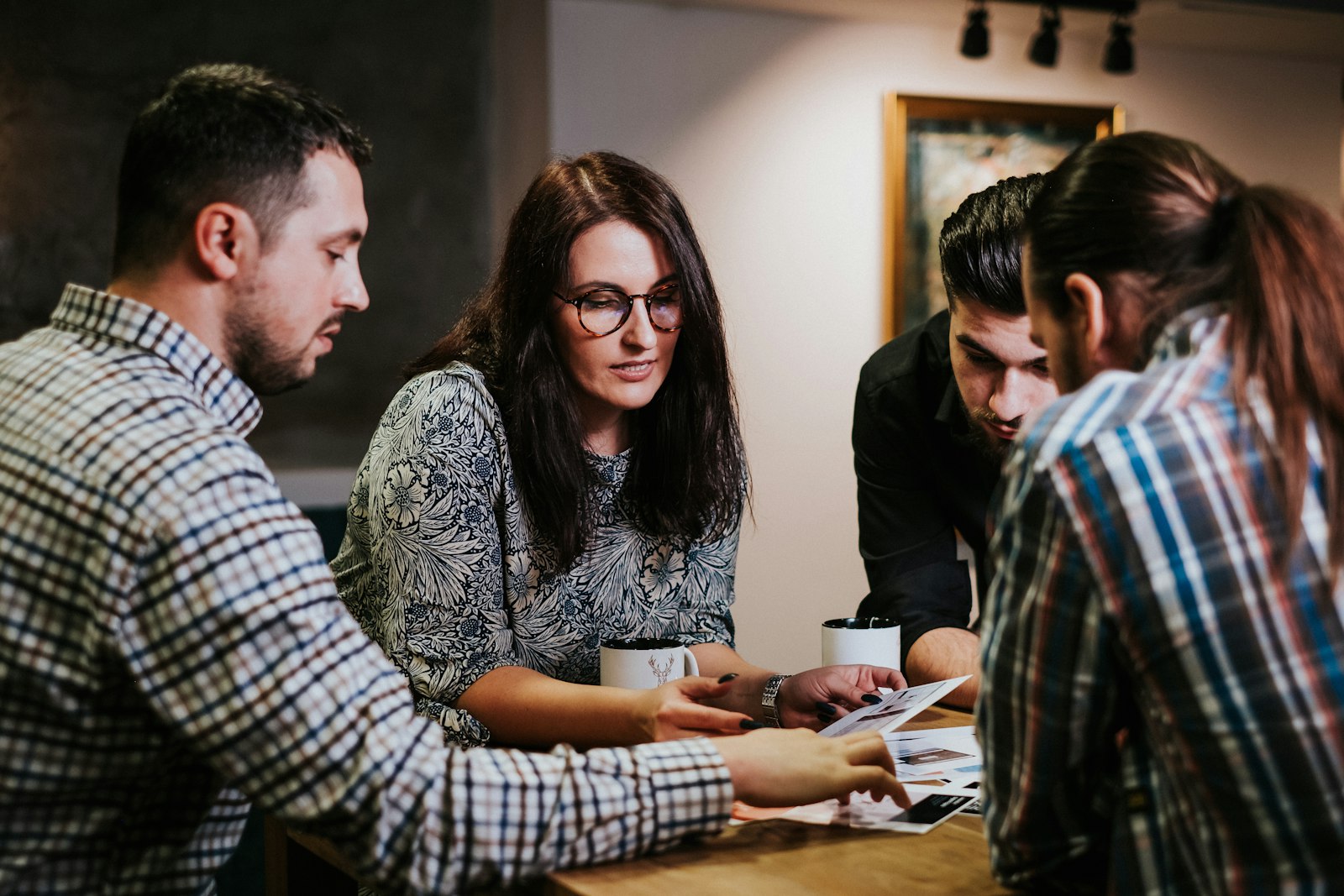 Team reviewing documents together while assessing product metrics
