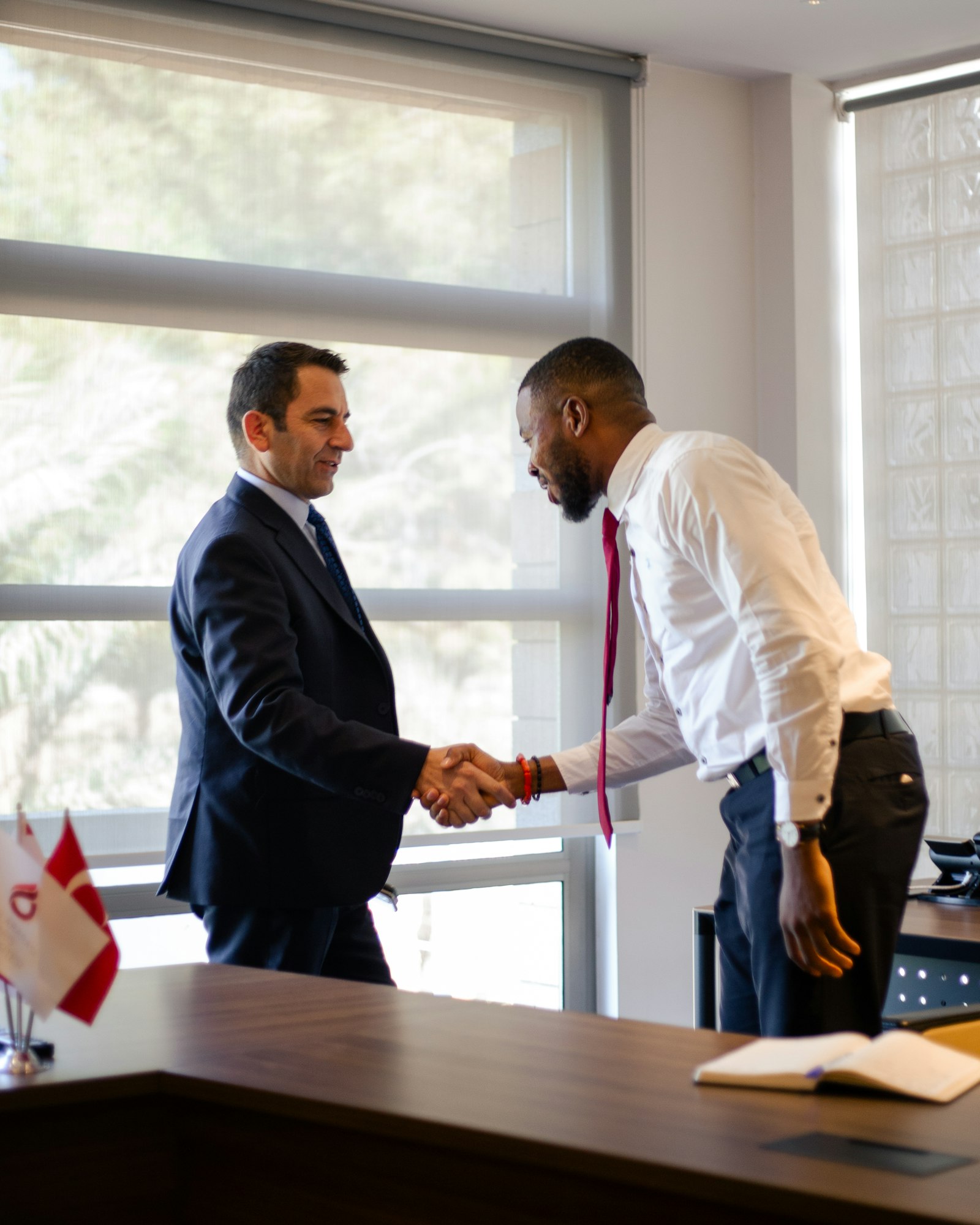 Two professionals shaking hands after an investor due-diligence meeting