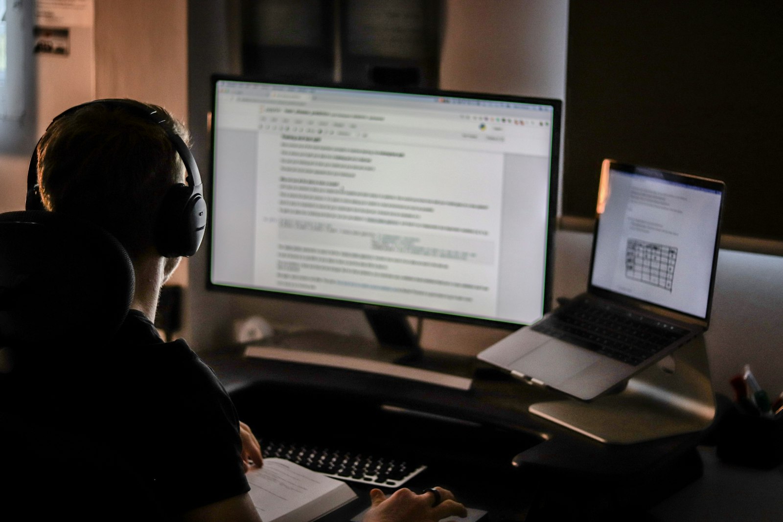 A developer on a video call with laptop and headphones