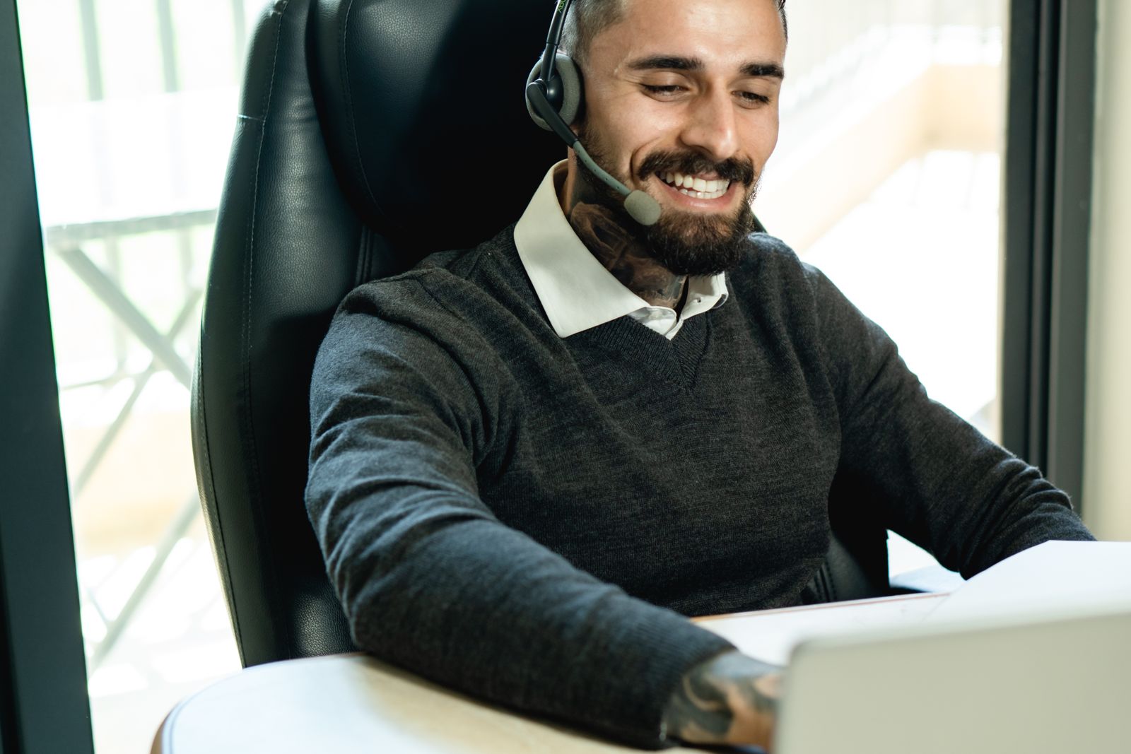 Support agent wearing a headset while working at the office